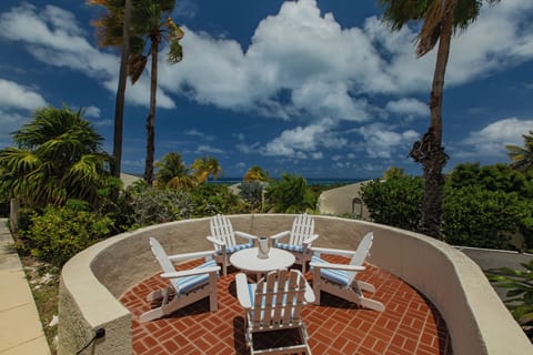 Private patio with Adirondack chairs and ocean views — the perfect spot for morn