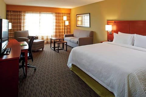 Unwind in a bright, spacious room with plush bedding.