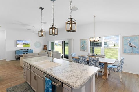 View of Kitchen Island, Dinning table and Livingroom. Large Table with 6 chairs