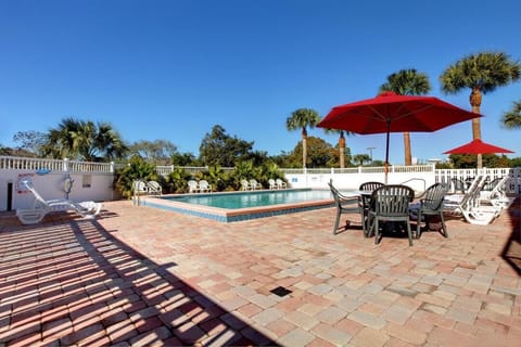 Lounge under bright umbrellas and soak up poolside sunshine.