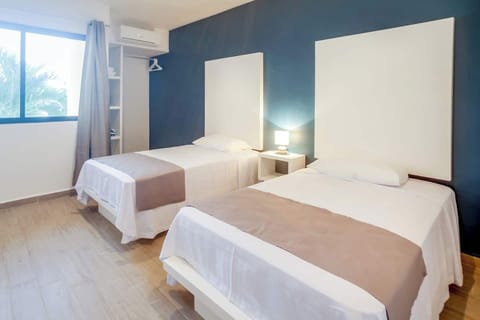 Bedroom with 2 single beds, safe box, hair dryer, closet and iron