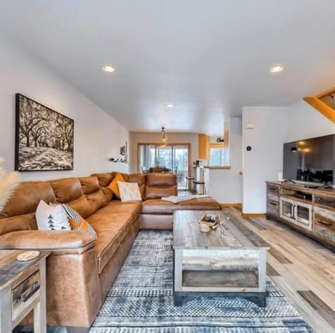 Cozy living room featuring a 56” Smart TV and a balcony with scenic views.
