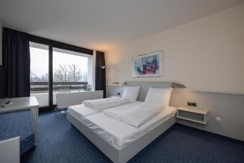 Unwind in crisp linens and wake to balcony views.