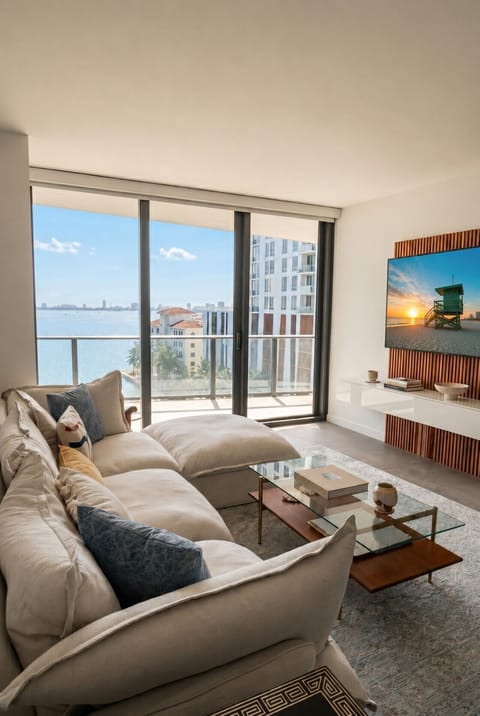 Spacious living area with TV and direct balcony access