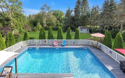 Private pool with spacious deck, lush yard, and room to relax outdoors