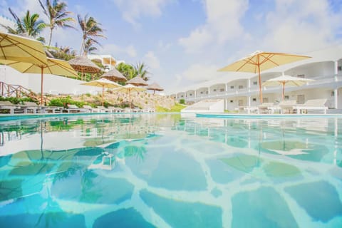 Dive into shimmering blue waters under breezy sun umbrellas