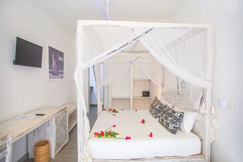 Linger in bed with relaxed views and serene white interiors.