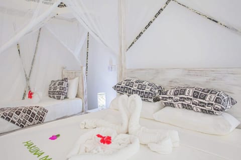 Wake refreshed in serene linens with romantic towel artistry.