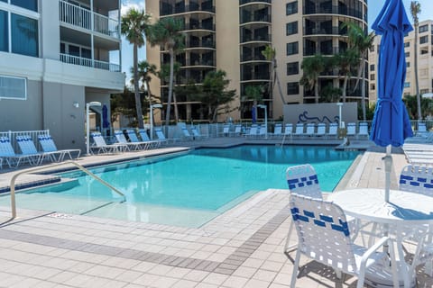 Gather poolside with shaded tables for breezy afternoons.