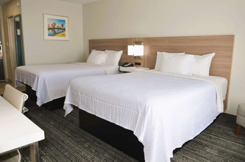 Unwind on crisp white linens in a spacious double-queen room.