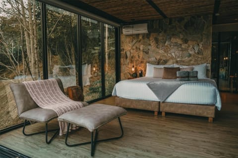 Drift off in a cozy suite framed by warm stone textures.