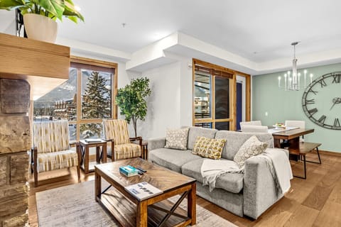 Cozy living area with fireplace, queen sofa bed, and balcony access.