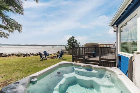 Soak in your private hot tub while gazing at the pristine beach just steps from your door.