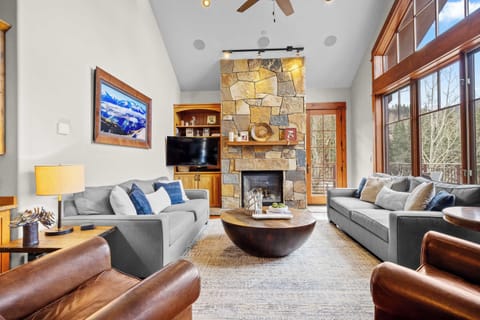 Living room: 2 sofas, 2 leather accent chairs, gas fireplace, Smart TV, patio access