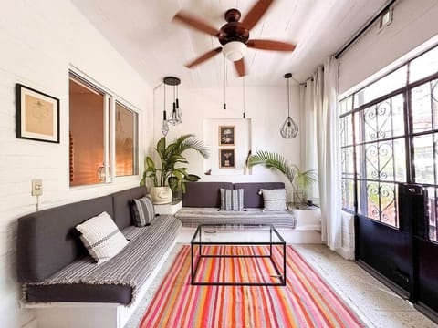 Sun-filled living space with built-in lounge seating and tropical accents — a calm, airy retreat perfect for slow mornings, reading, or unwinding after a day in Puerto Vallarta.