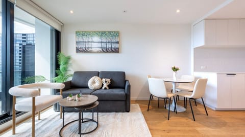 Relax in a bright, spacious living area with comfy seating and smart TV.