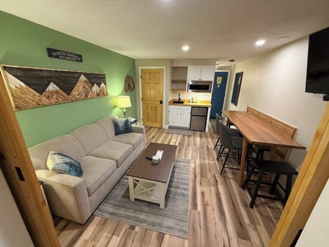 Recharge in this inviting suite, featuring a dining area, & TV​