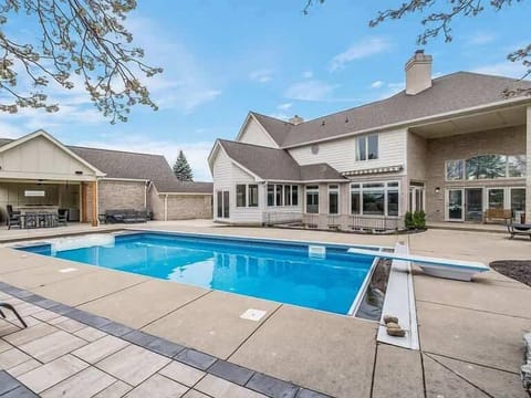 Sparkling outdoor pool w/ surrounding patio seating, perfect for sunny days & relaxing swims