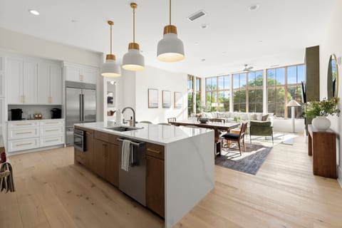 Sunlit chef’s kitchen and airy lounge with floor-to-ceiling windows
