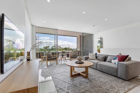 Contemporary open-plan living filled with natural light, where comfortable seating and elevated outlooks create an inviting place to relax after a day exploring Noosa.