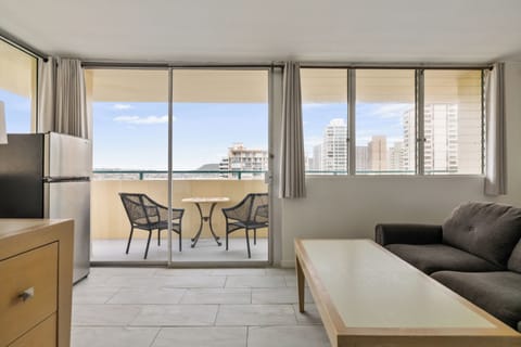 Relax in your modern living space with stunning city views through floor-to-ceiling windows and step onto your private balcony for fresh air.