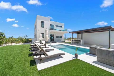Welcome to your modern villa oasis in beautiful Long Bay Hills.