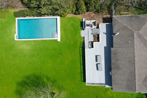 Backyard with heated pool. outdoor shower and spacious deck, perfect for BBQs and relax. 