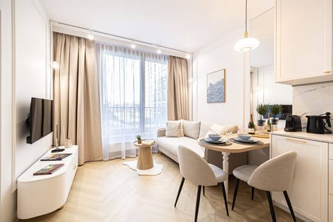 Stylish living room with kitchen and dining area in a new apartment close to Opera Nova and the city center attractions.