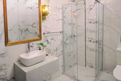 Indulge in a spa-bright marble bath with glass shower.