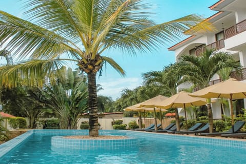 Lounge poolside under umbrellas with cooling island views.