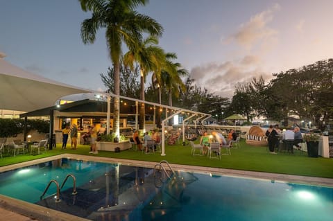 Sip sunset cocktails by the water under glowing lights.
