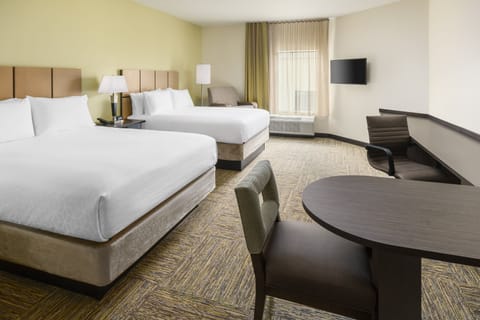 Unwind in a spacious double-queen room with cozy workspace.
