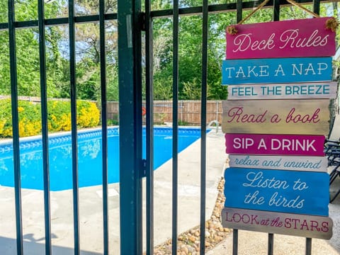 A close-up of the pool sign adds a playful, welcoming touch to the space, bringing in a bit of personality and charm. It’s a small detail that makes the backyard feel more fun, relaxed, and thoughtfully put together.