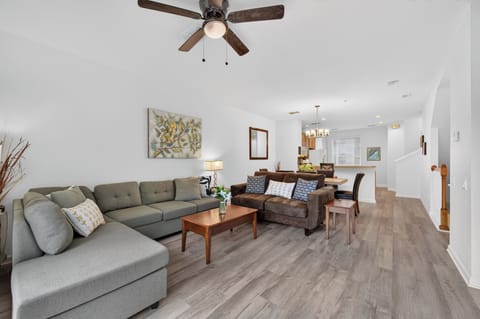 Settle into your bright, open living space where the ceiling fan cools you as you relax on plush seating. The airy layout seamlessly connects lounging and dining, making it easy to unwind or gather with loved ones.
