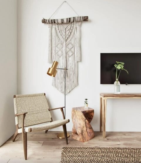 Unwind with a quiet read beside warm, curated coastal decor.