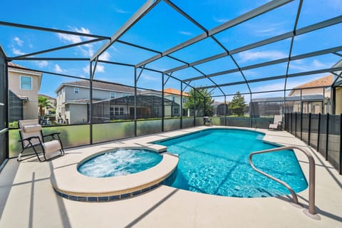 Resort-style screened pool area w/ spa seating, perfect for sunny afternoons & evening swims