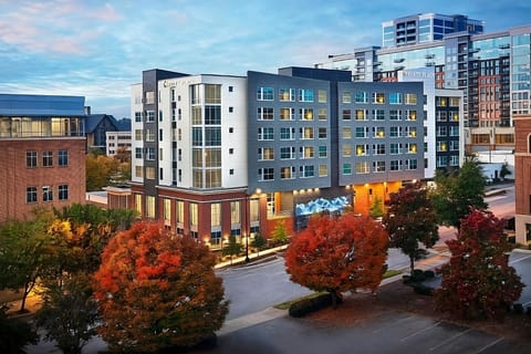 Arrive to a sleek, modern building glowing at sunset.
