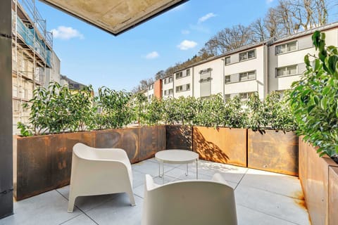 Spacious private terrace with outdoor seating, perfect for relaxing and enjoying fresh air.