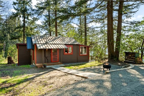 Cabin Exterior | Forest Setting & Water Glimpse | Fire Pit Area