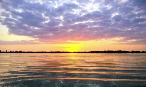 The winter sun sets over Lemon Bay, as seen from the mouth Lake Drive's private canal. Spectacular views like this happen daily, and are best taken in from a kayak or paddleboard.
