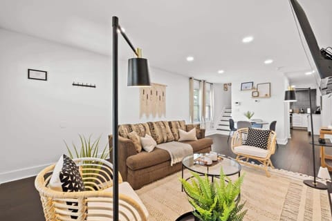 Relax in this cozy, thoughtfully designed living area featuring comfortable seating, warm modern décor, and ample lighting. Enjoy movie nights on the large TV, unwind with a book, or gather with friends in this inviting open space.