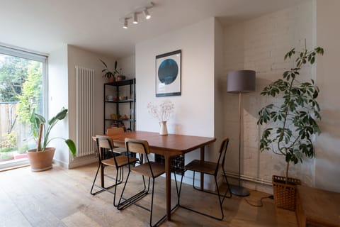 A spacious open-plan kitchen, dining area, and living room with garden access