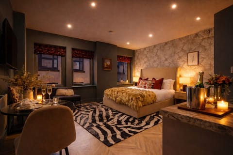 Modern open-plan living space with Smart TV, fully equipped kitchen, and dining area — right on The Headrow, Leeds city centre