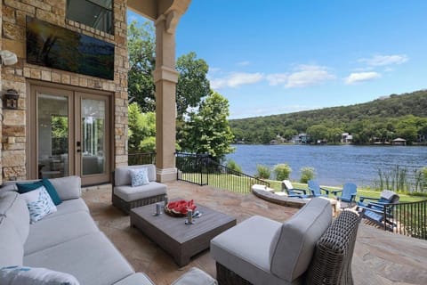 Covered stone patio opening straight onto the Lake Austin water