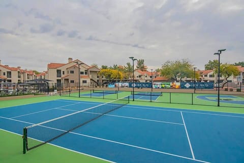 Enjoy a match on this wide-open tennis court, perfect for a sunny day!
