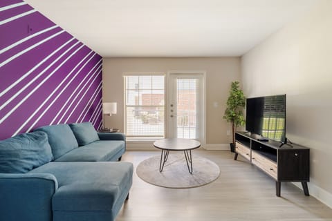 Bright living room with bold accent wall, comfy sectional, and natural light