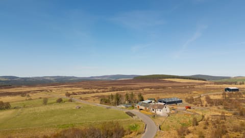 Lynemore Croft from above — nestled beside a working farm on the scenic Grantown-on-Spey to Tomintoul road, surrounded by open Highland countryside.