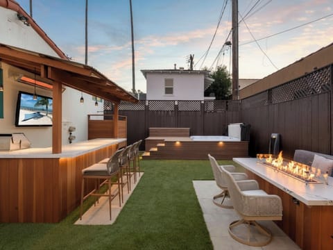 Unwind in your private backyard oasis, featuring a relaxing hot tub,