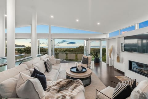 Spacious open plan living with gas fireplace for feeling cosy in winter, and bi-fold doors opening out to the deck overlooking the sand dunes for uninterrupted ocean views all year round.