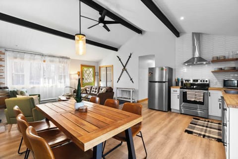 Open kitchen and dining great room with exposed beams